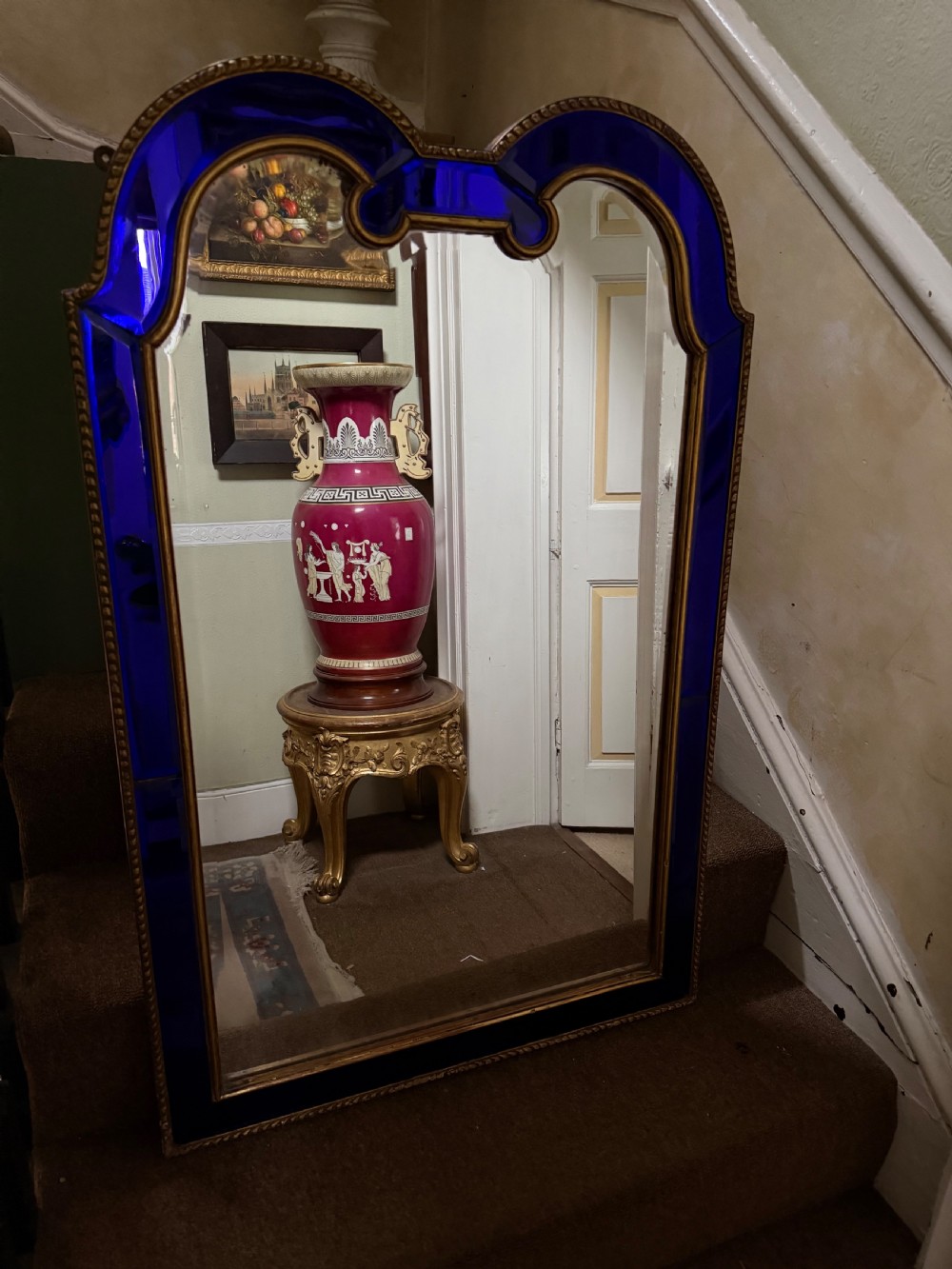 A late 19th-century wall mirror featuring a shaped arched top, cobalt blue glass margin borders, and an ornate gilded inner and outer moulding. View VI