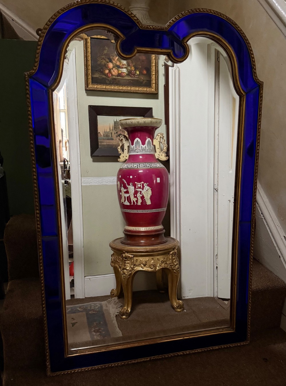 A late 19th-century wall mirror featuring a shaped arched top, cobalt blue glass margin borders, and an ornate gilded inner and outer moulding. View XI