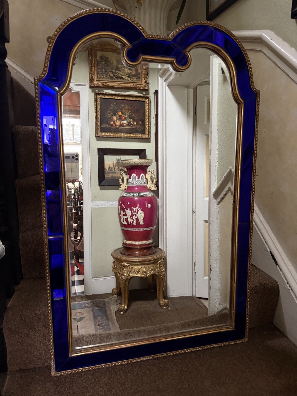 A late 19th-century wall mirror featuring a shaped arched top, cobalt blue glass margin borders, and an ornate gilded inner and outer moulding. View XIII