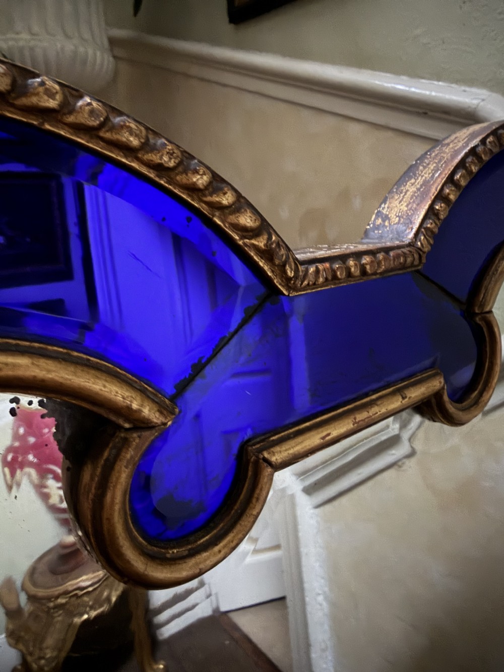 A late 19th-century wall mirror featuring a shaped arched top, cobalt blue glass margin borders, and an ornate gilded inner and outer moulding. View XIV