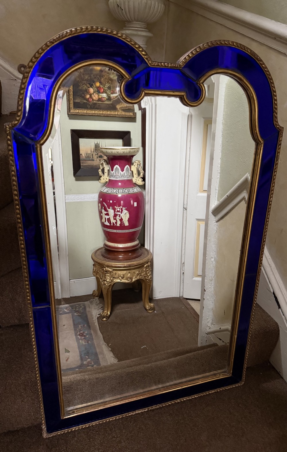 A late 19th-century wall mirror featuring a shaped arched top, cobalt blue glass margin borders, and an ornate gilded inner and outer moulding. View XVII