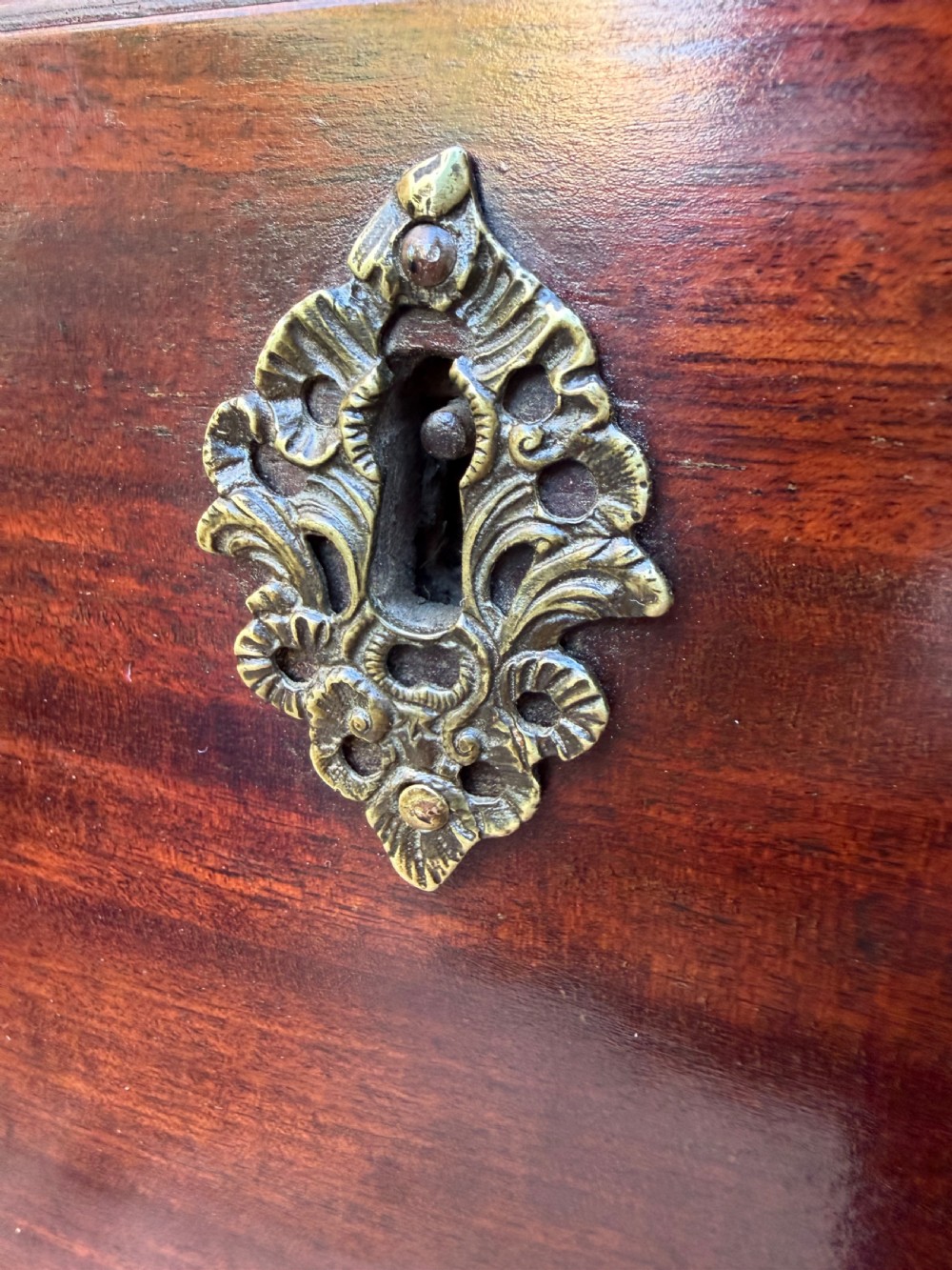 A mid-18th century George II red walnut chest-on-chest featuring a dentil moulded cornice, brass swan-neck handles, and bracket feet. View XI