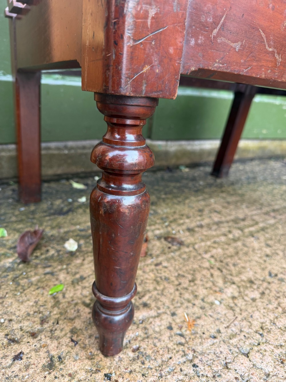 A mid-19th century mahogany luggage stand with a slatted platform, turned front legs, and a raised raked rear upstand. View IV