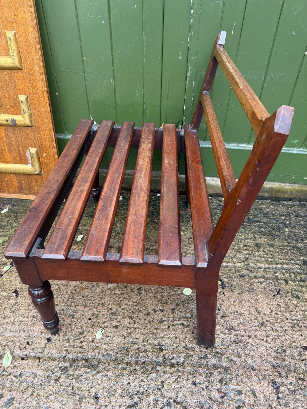 A mid-19th century mahogany luggage stand with a slatted platform, turned front legs, and a raised raked rear upstand. View VIII