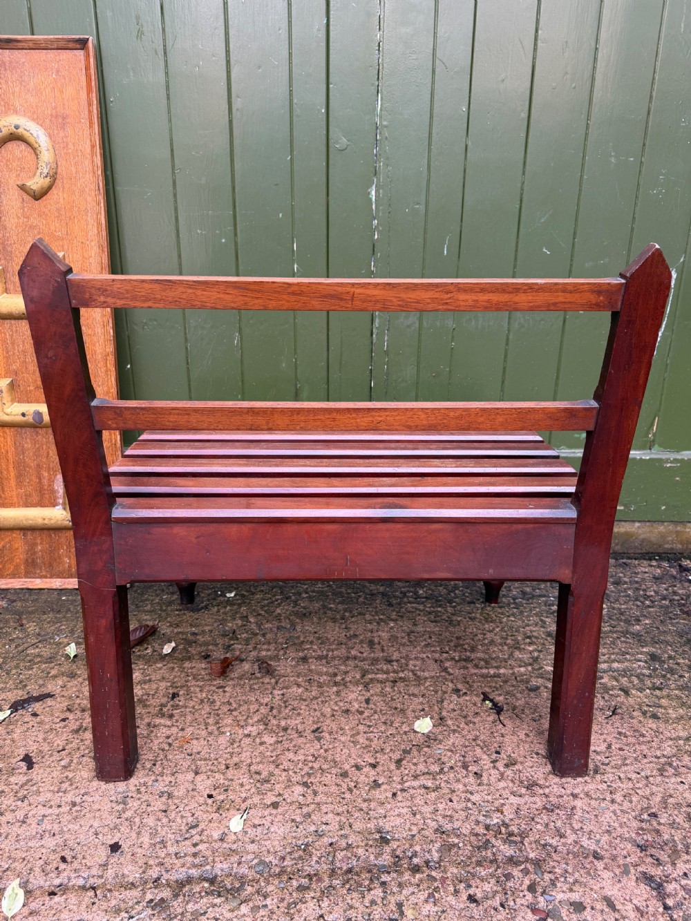 A mid-19th century mahogany luggage stand with a slatted platform, turned front legs, and a raised raked rear upstand. View IX