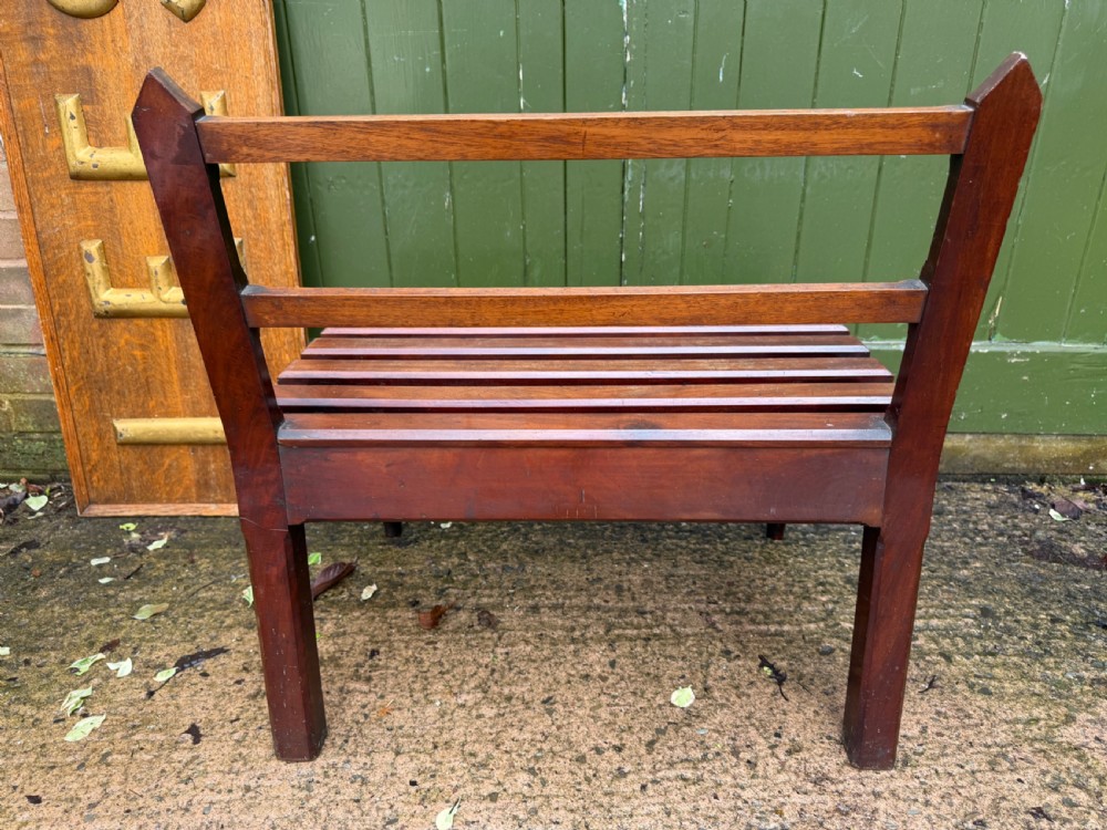 A mid-19th century mahogany luggage stand with a slatted platform, turned front legs, and a raised raked rear upstand. View X