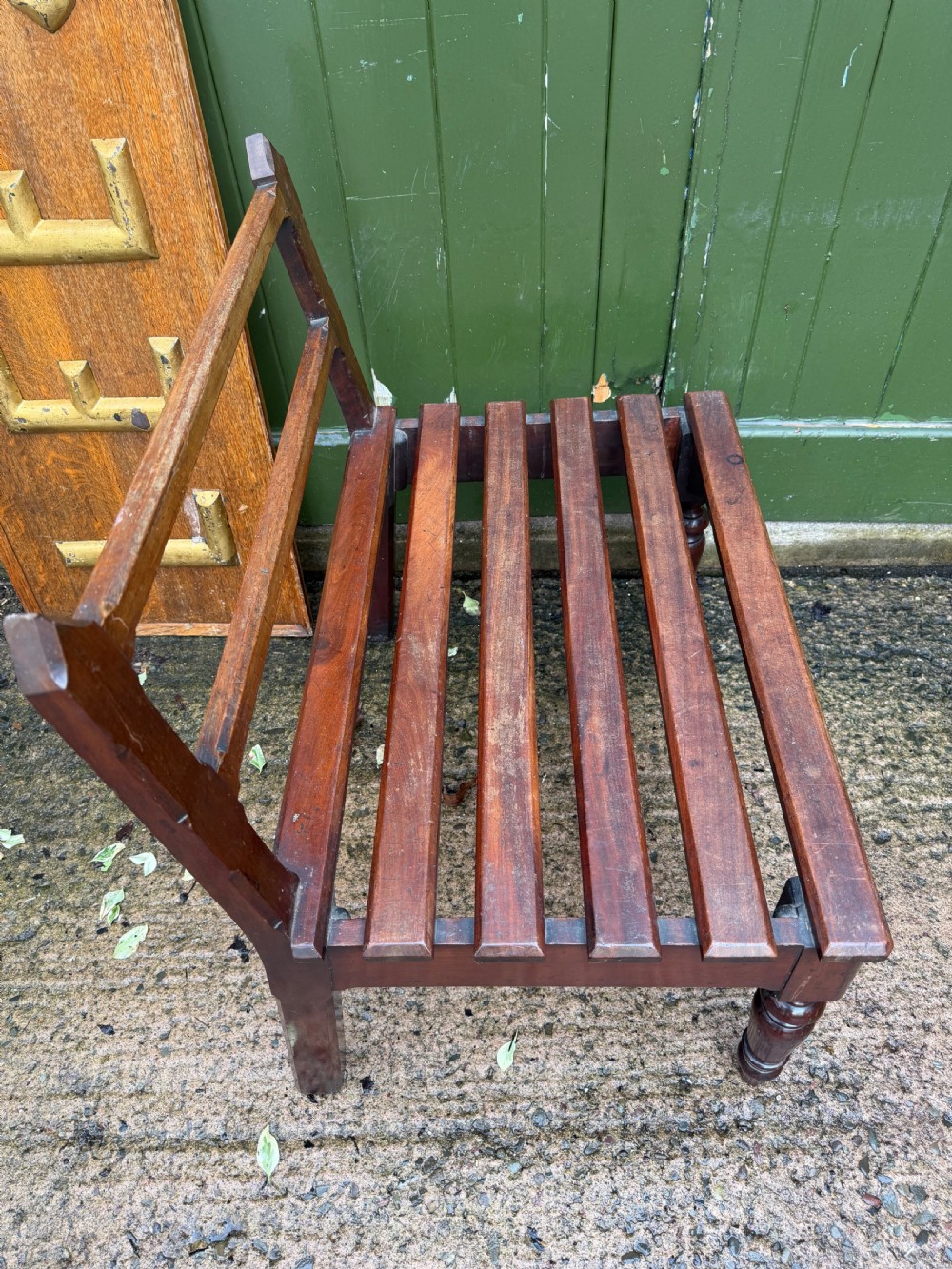 A mid-19th century mahogany luggage stand with a slatted platform, turned front legs, and a raised raked rear upstand. View XII