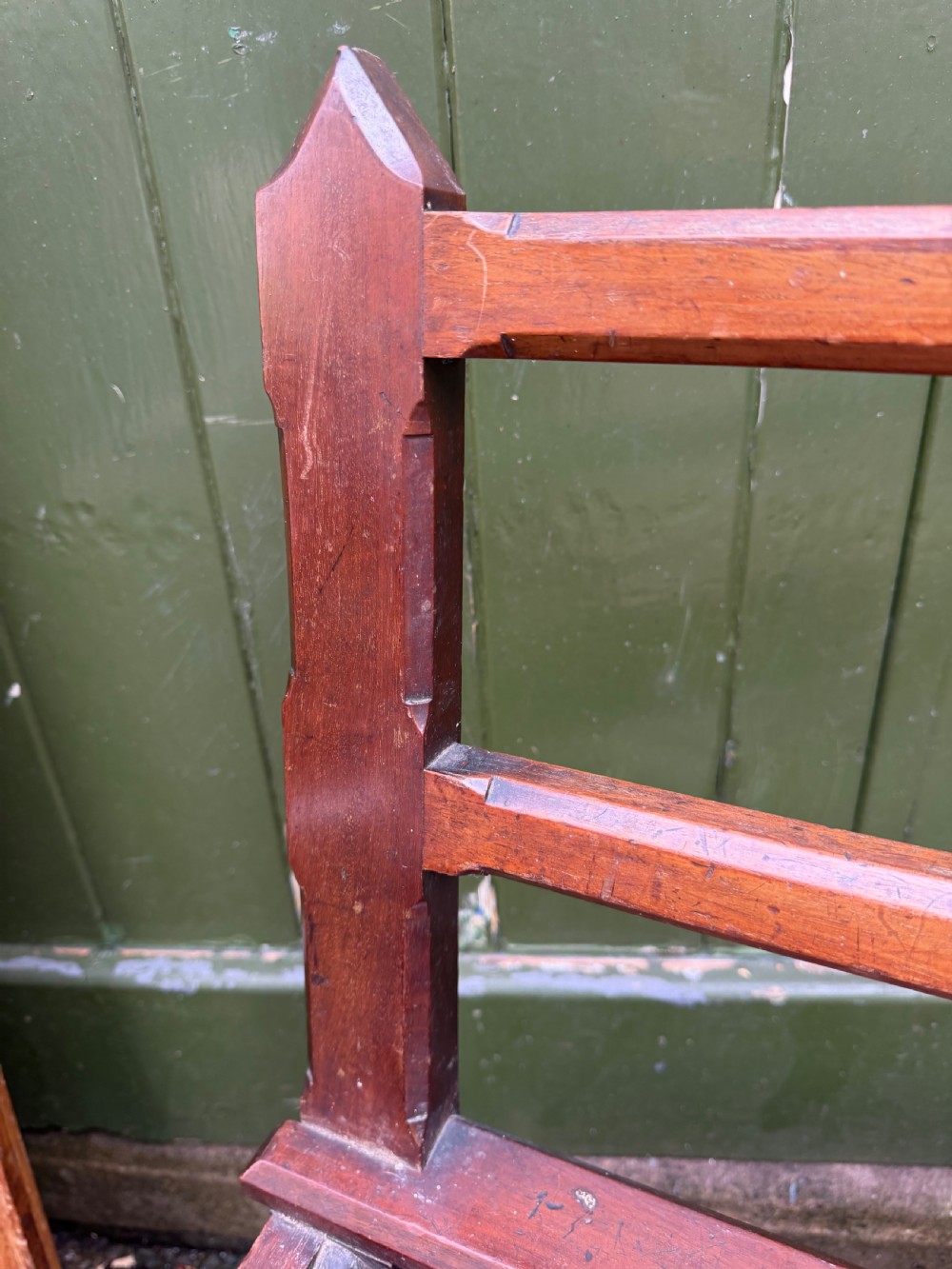 A mid-19th century mahogany luggage stand with a slatted platform, turned front legs, and a raised raked rear upstand. View XIII