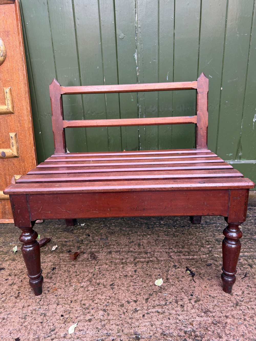 A mid-19th century mahogany luggage stand with a slatted platform, turned front legs, and a raised raked rear upstand. View XV