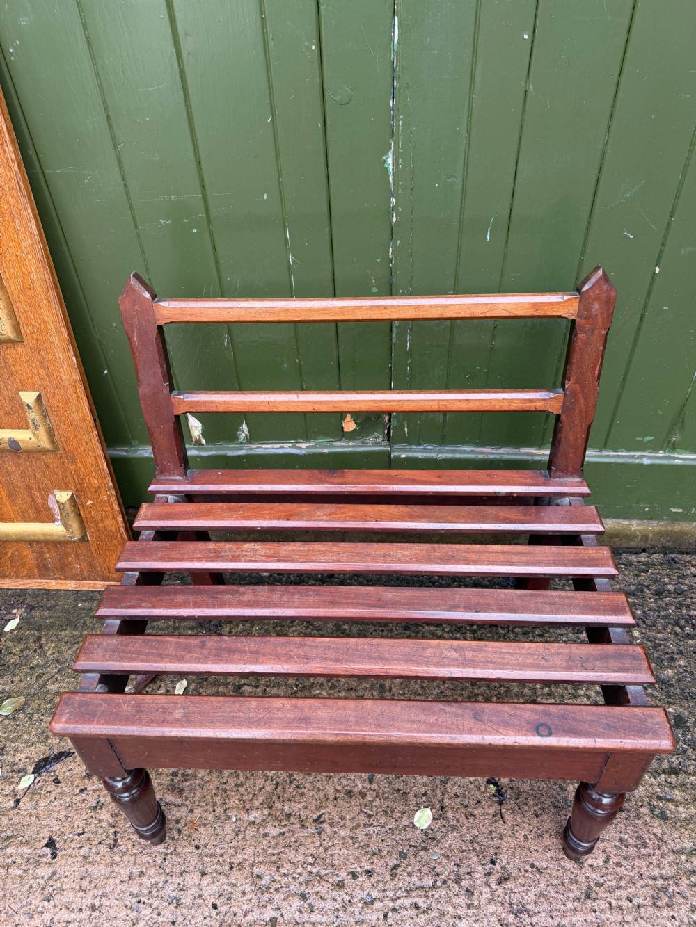 A mid-19th century mahogany luggage stand with a slatted platform, turned front legs, and a raised raked rear upstand. View XVII
