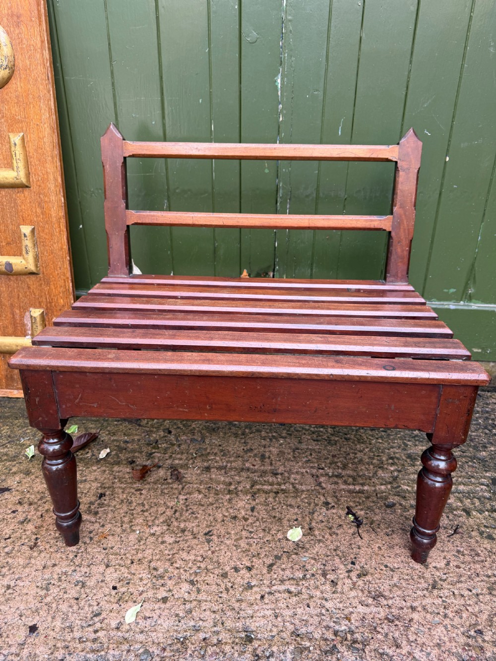 A mid-19th century mahogany luggage stand with a slatted platform, turned front legs, and a raised raked rear upstand. View XVIII