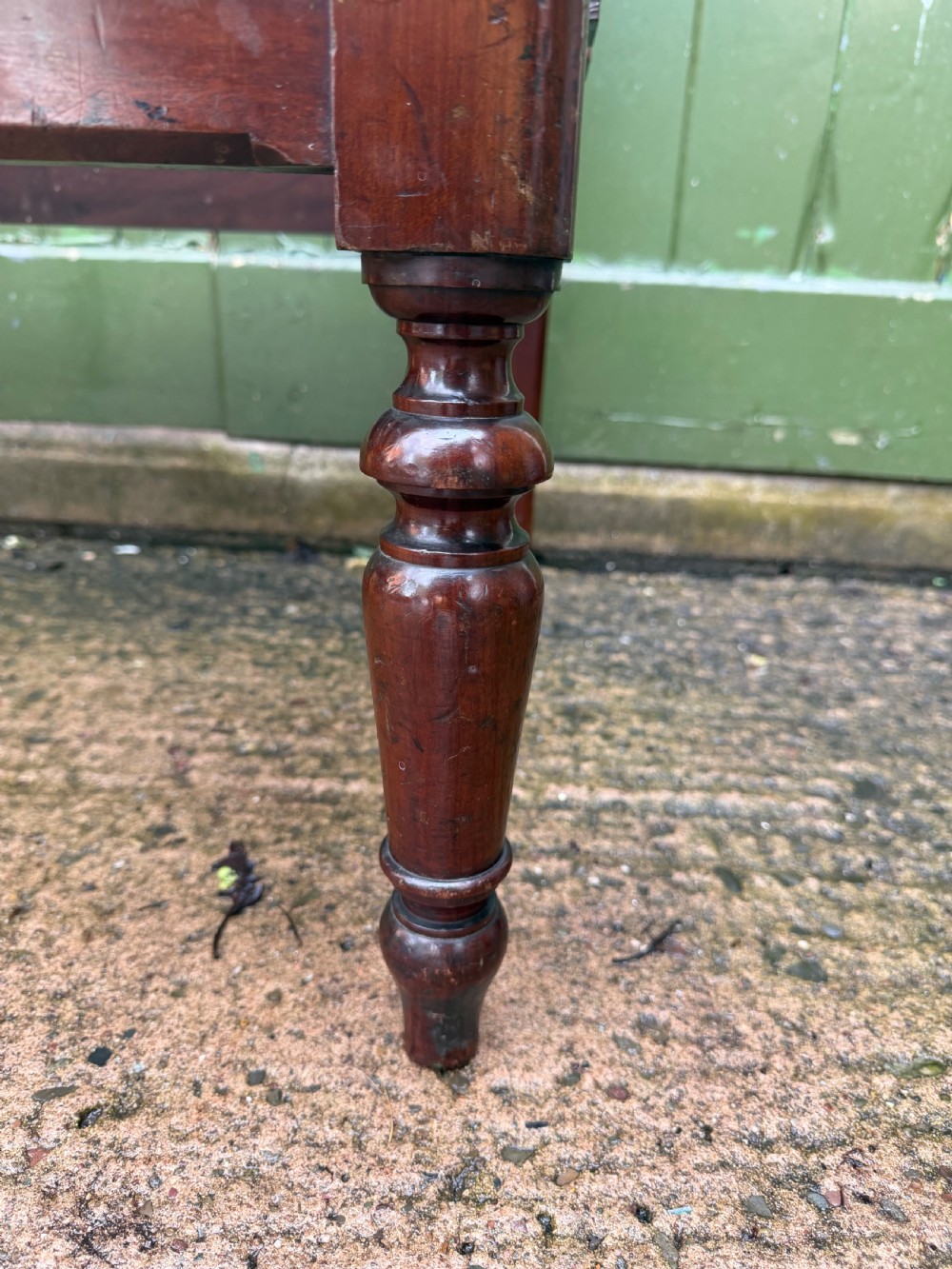 A mid-19th century mahogany luggage stand with a slatted platform, turned front legs, and a raised raked rear upstand. View XX