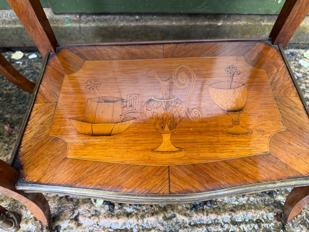 A pair of French marquetry bedside tables featuring three drawers with floral inlays, brass mounts, curved legs, and a lower tier shelf. View VIII