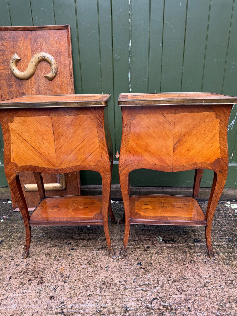 A pair of French marquetry bedside tables featuring three drawers with floral inlays, brass mounts, curved legs, and a lower tier shelf. View XIII