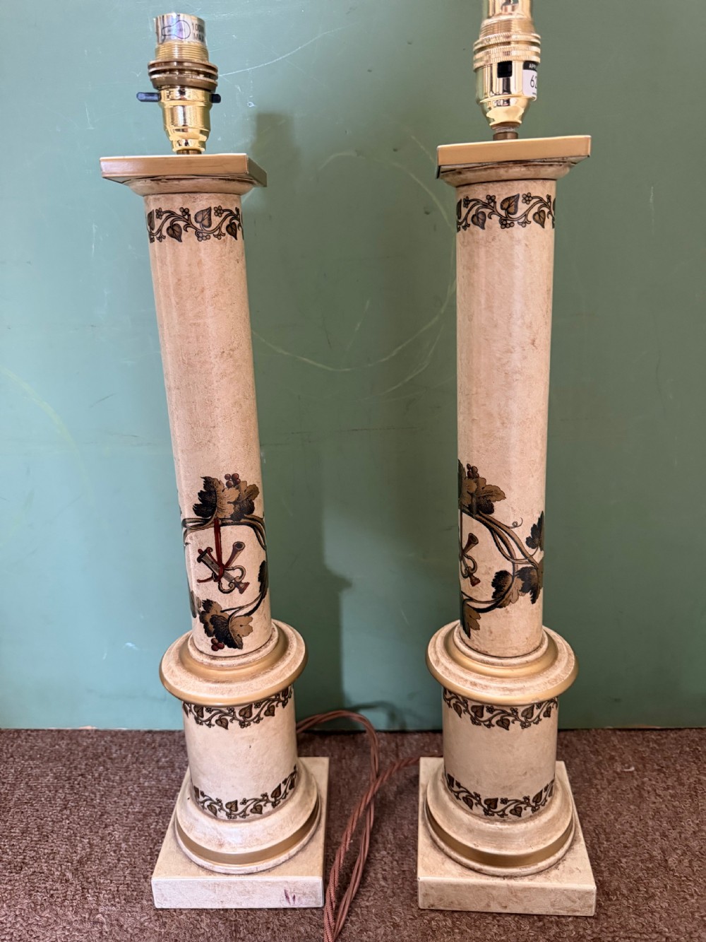A pair of early twentieth-century French cream tole-peinte column table lamps decorated with hand-painted vine leaves, musical motifs, and gilt trim. View IV