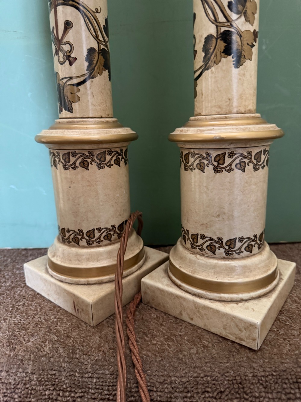 A pair of early twentieth-century French cream tole-peinte column table lamps decorated with hand-painted vine leaves, musical motifs, and gilt trim. View XI