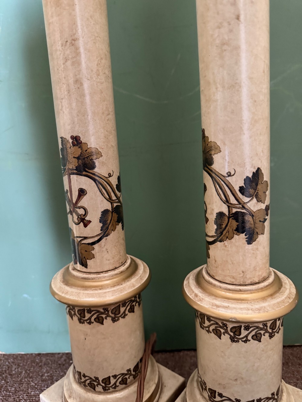 A pair of early twentieth-century French cream tole-peinte column table lamps decorated with hand-painted vine leaves, musical motifs, and gilt trim. View XII