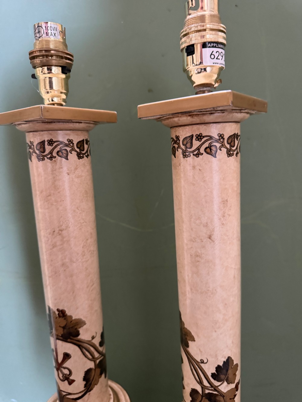 A pair of early twentieth-century French cream tole-peinte column table lamps decorated with hand-painted vine leaves, musical motifs, and gilt trim. View XIII