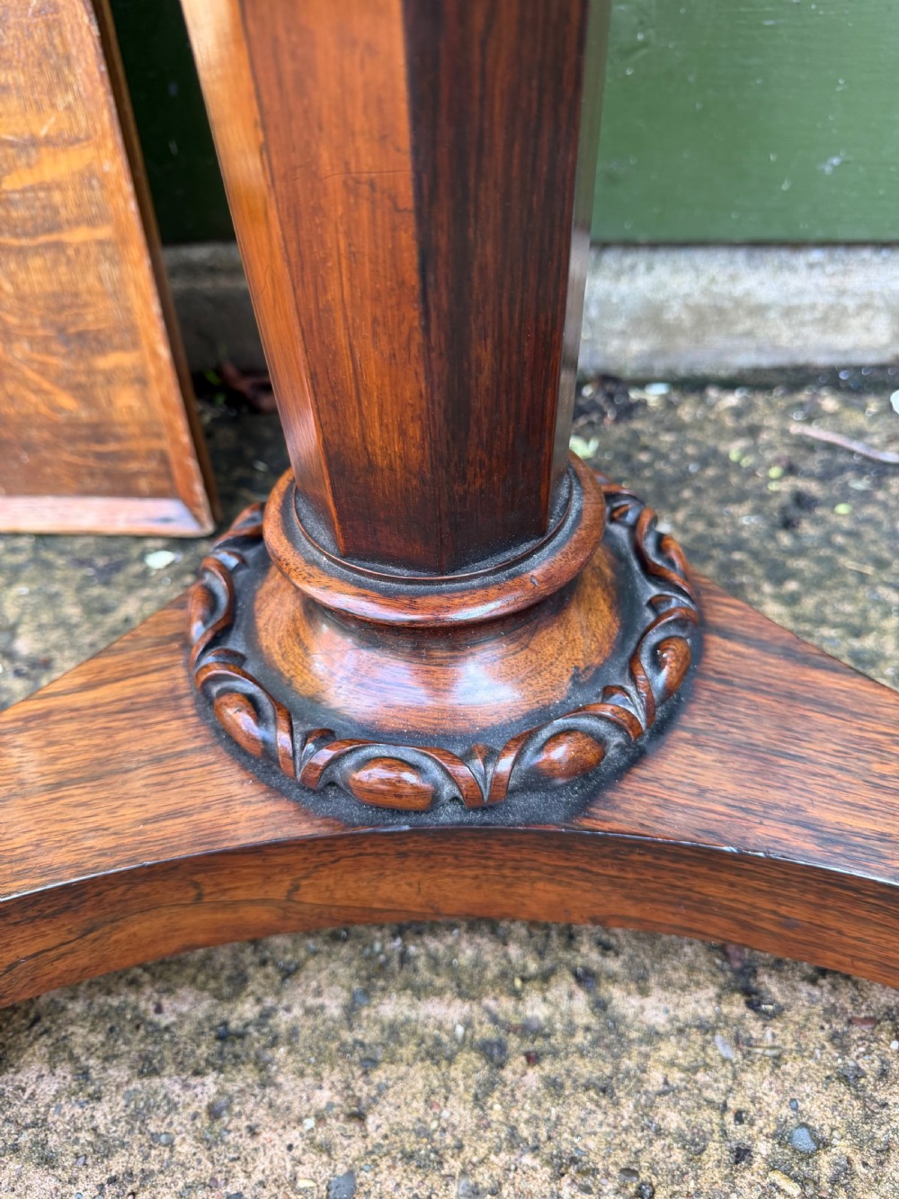 An early nineteenth-century circular rosewood occasional table featuring a deep apron, a faceted central pedestal, and a triform base with carved detail. View II