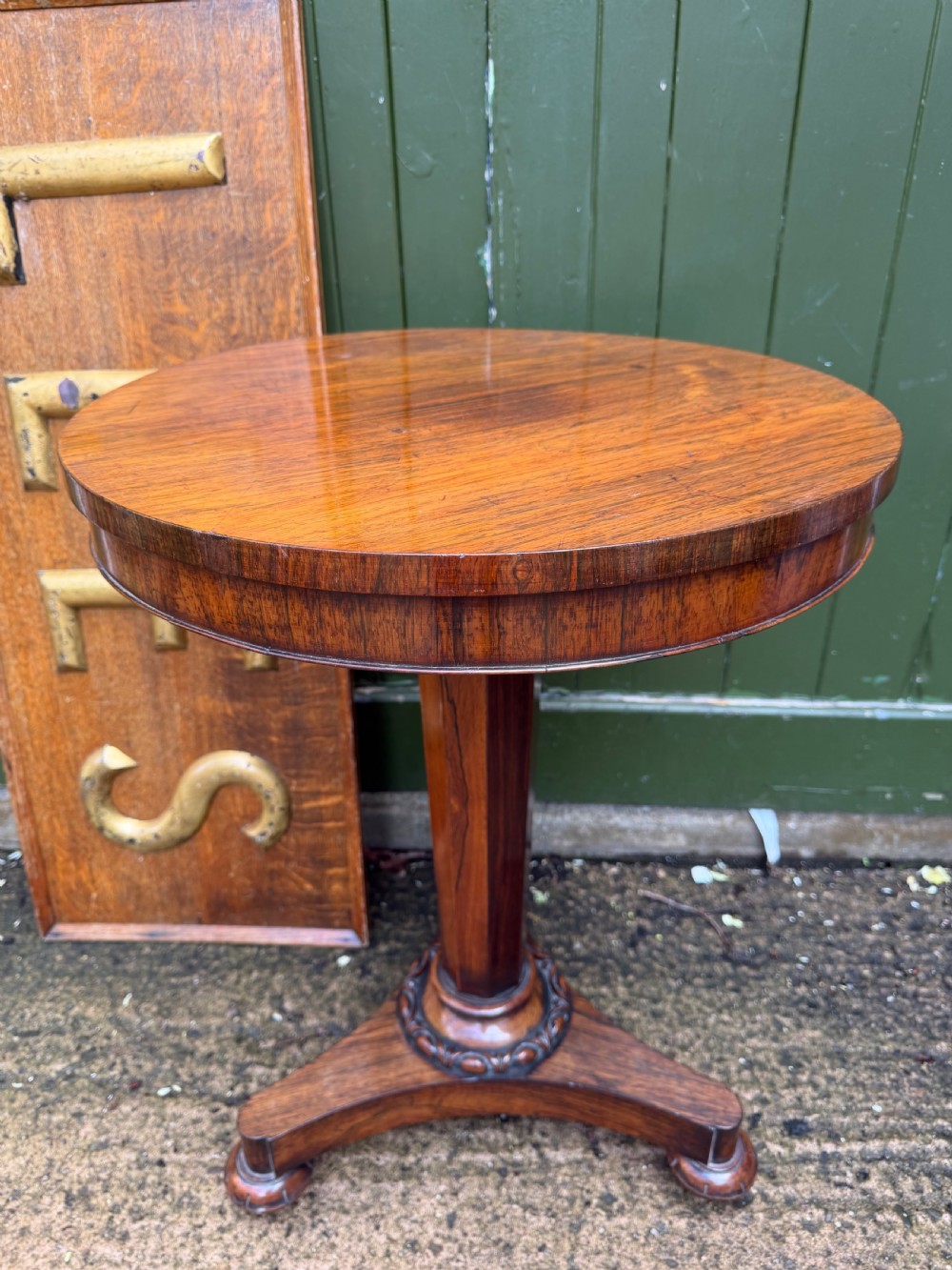 An early nineteenth-century circular rosewood occasional table featuring a deep apron, a faceted central pedestal, and a triform base with carved detail. View III