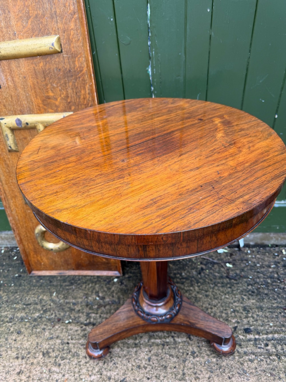 An early nineteenth-century circular rosewood occasional table featuring a deep apron, a faceted central pedestal, and a triform base with carved detail. View IV