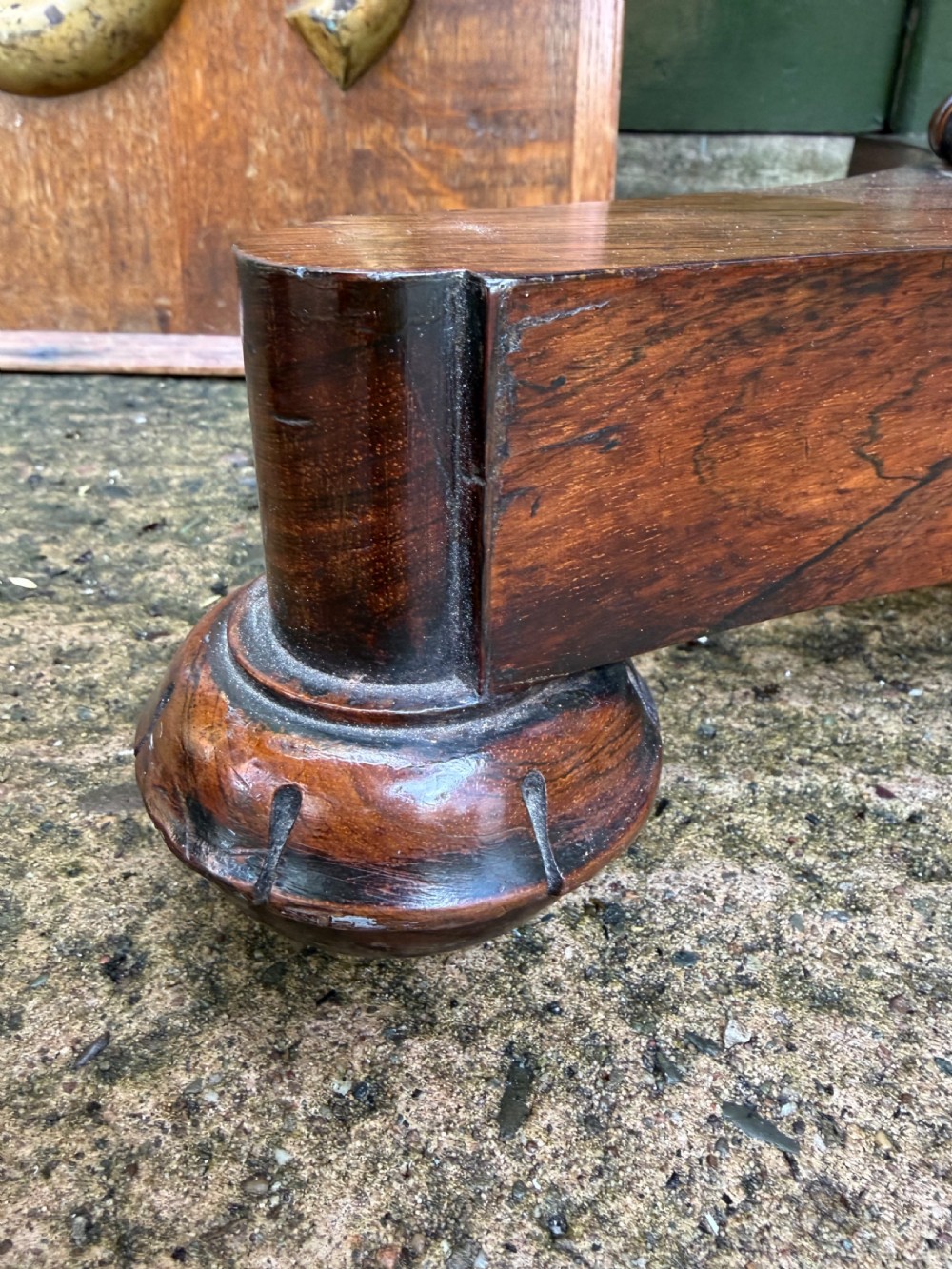 An early nineteenth-century circular rosewood occasional table featuring a deep apron, a faceted central pedestal, and a triform base with carved detail. View V