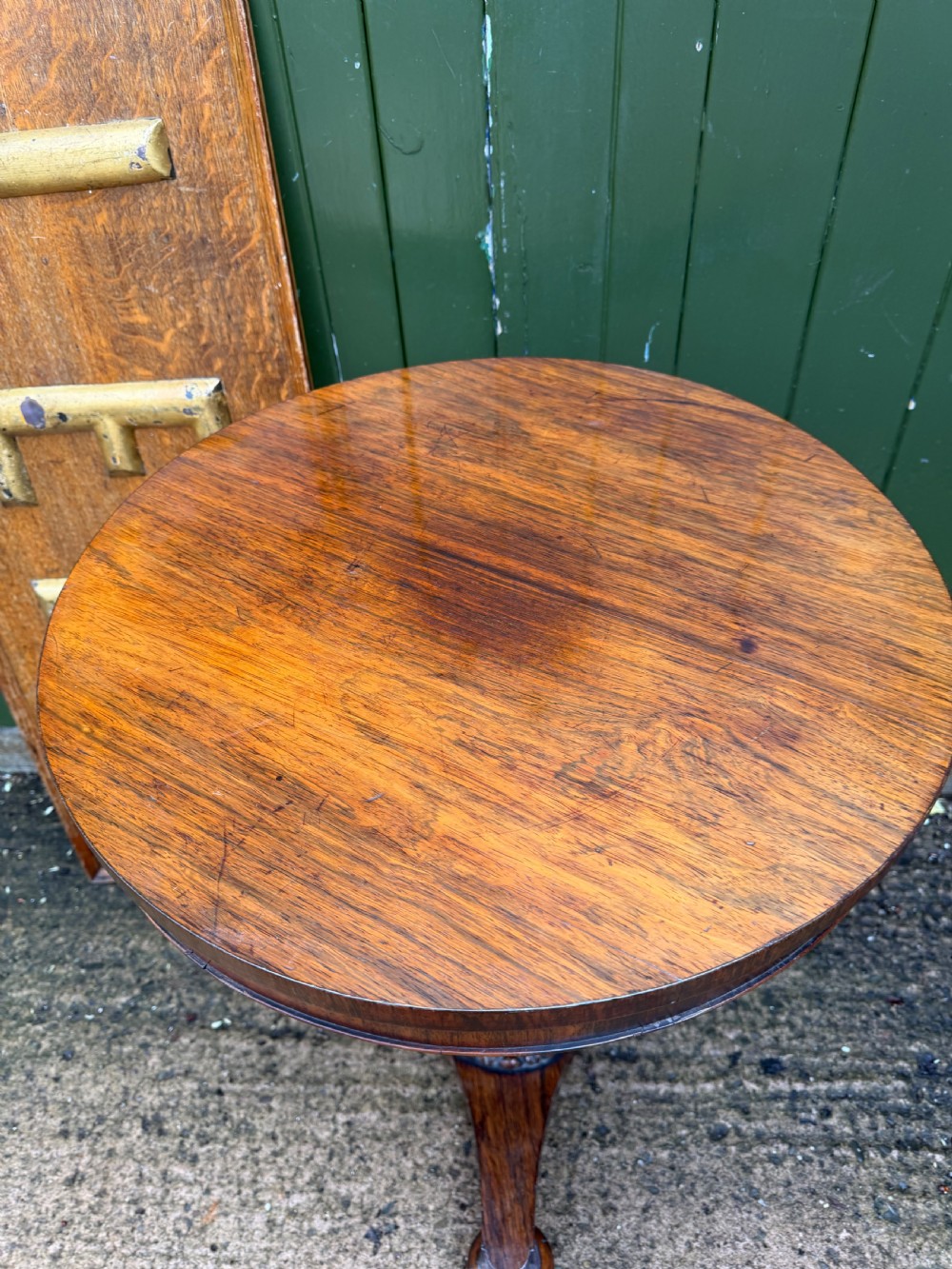 An early nineteenth-century circular rosewood occasional table featuring a deep apron, a faceted central pedestal, and a triform base with carved detail. View VIII