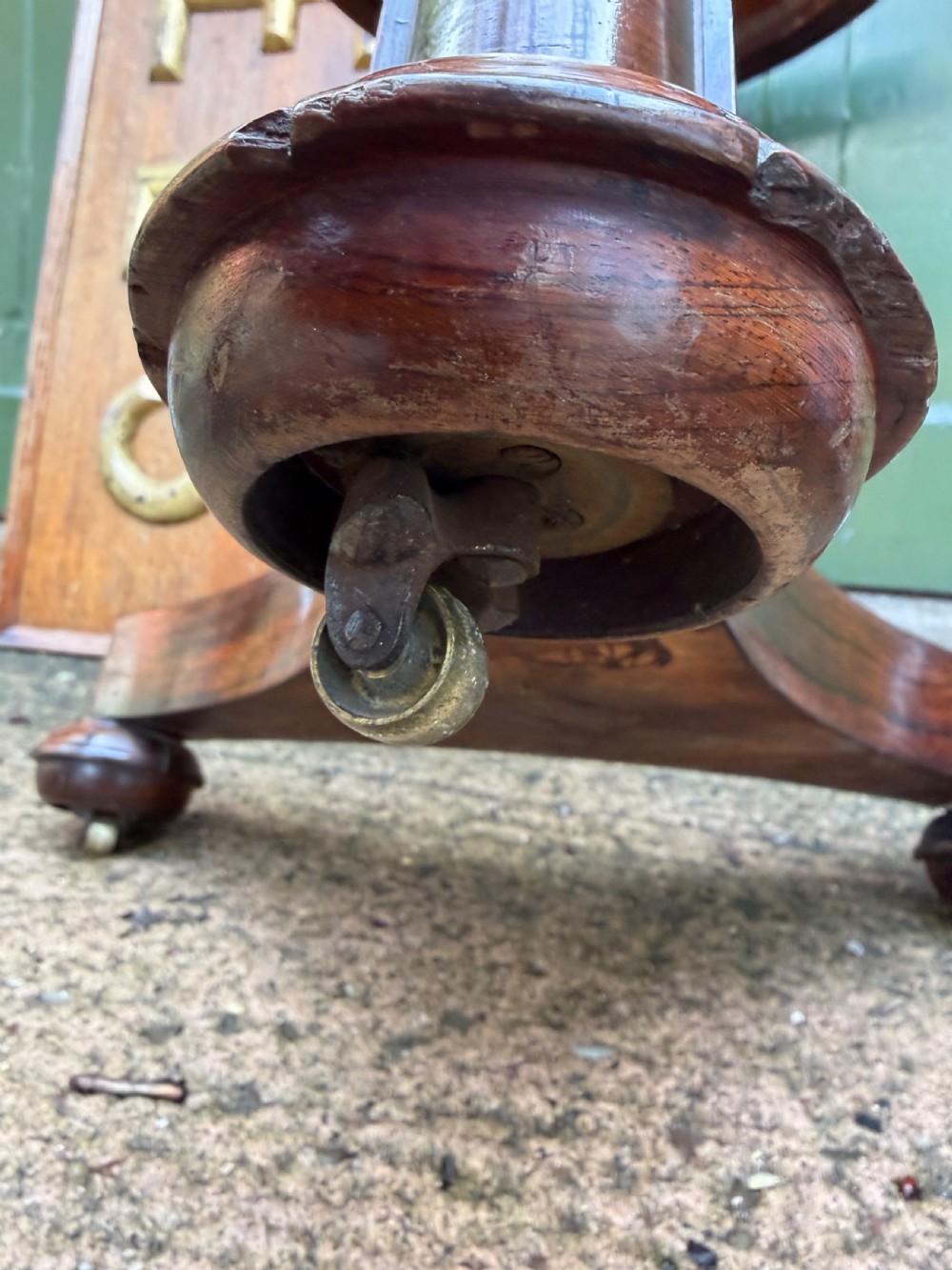 An early nineteenth-century circular rosewood occasional table featuring a deep apron, a faceted central pedestal, and a triform base with carved detail. View X