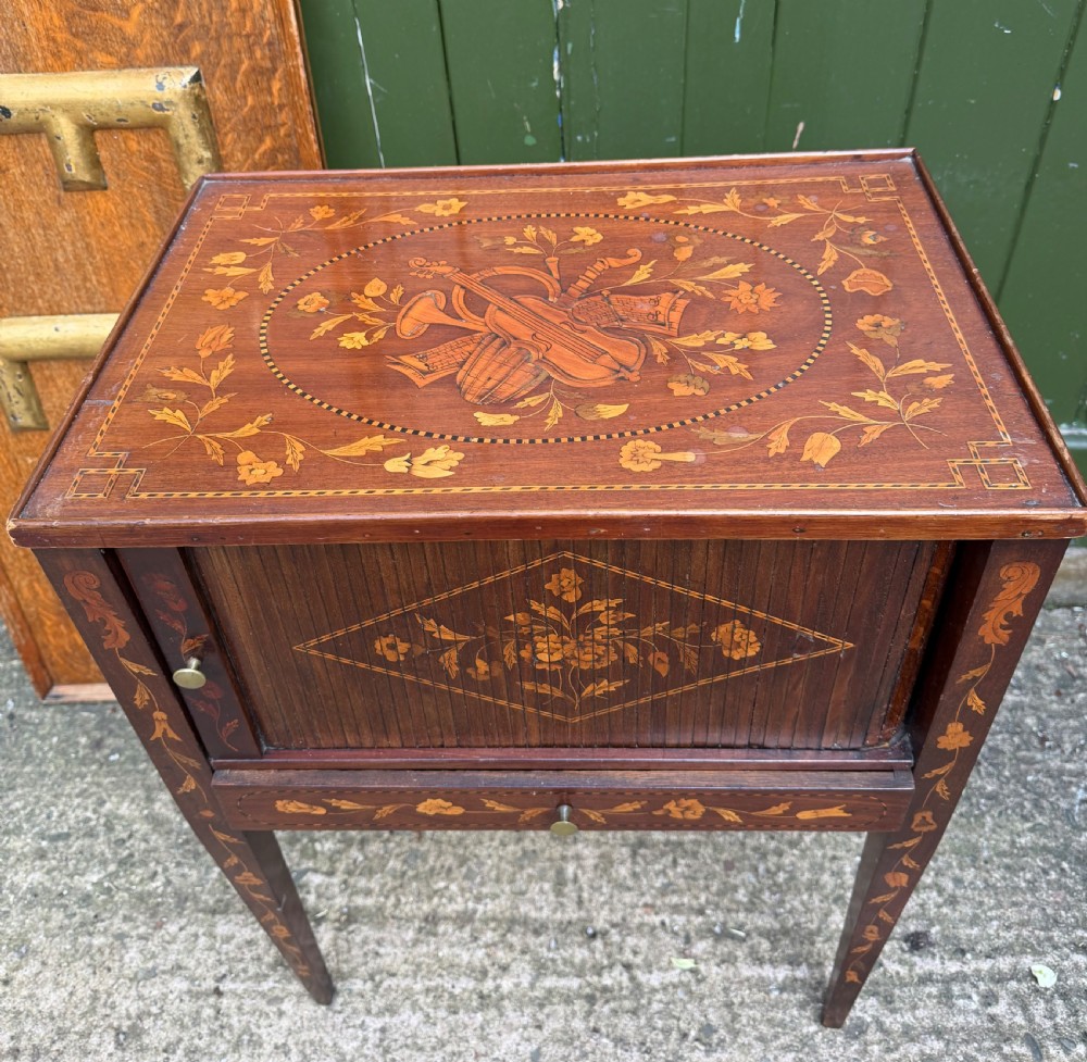 A Dutch mahogany bedside cupboard featuring floral marquetry inlays, a tambour slatted door, a single lower drawer with brass handles, and square tapered legs. View II
