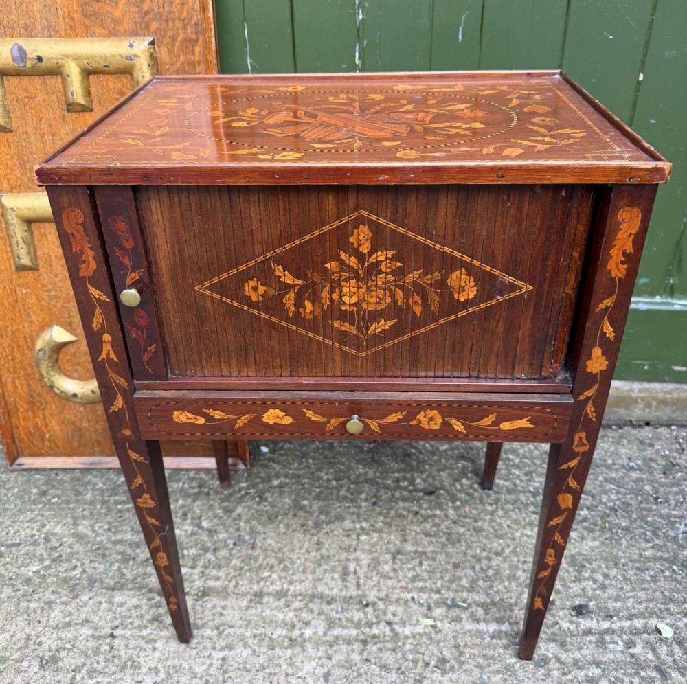 A Dutch mahogany bedside cupboard featuring floral marquetry inlays, a tambour slatted door, a single lower drawer with brass handles, and square tapered legs. View III