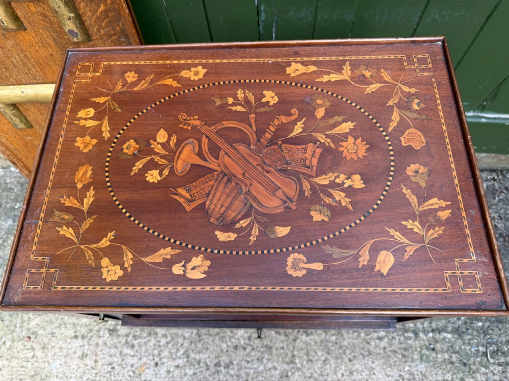 A Dutch mahogany bedside cupboard featuring floral marquetry inlays, a tambour slatted door, a single lower drawer with brass handles, and square tapered legs. View IV