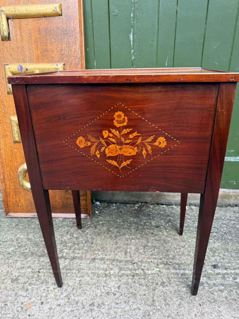 A Dutch mahogany bedside cupboard featuring floral marquetry inlays, a tambour slatted door, a single lower drawer with brass handles, and square tapered legs. View VII