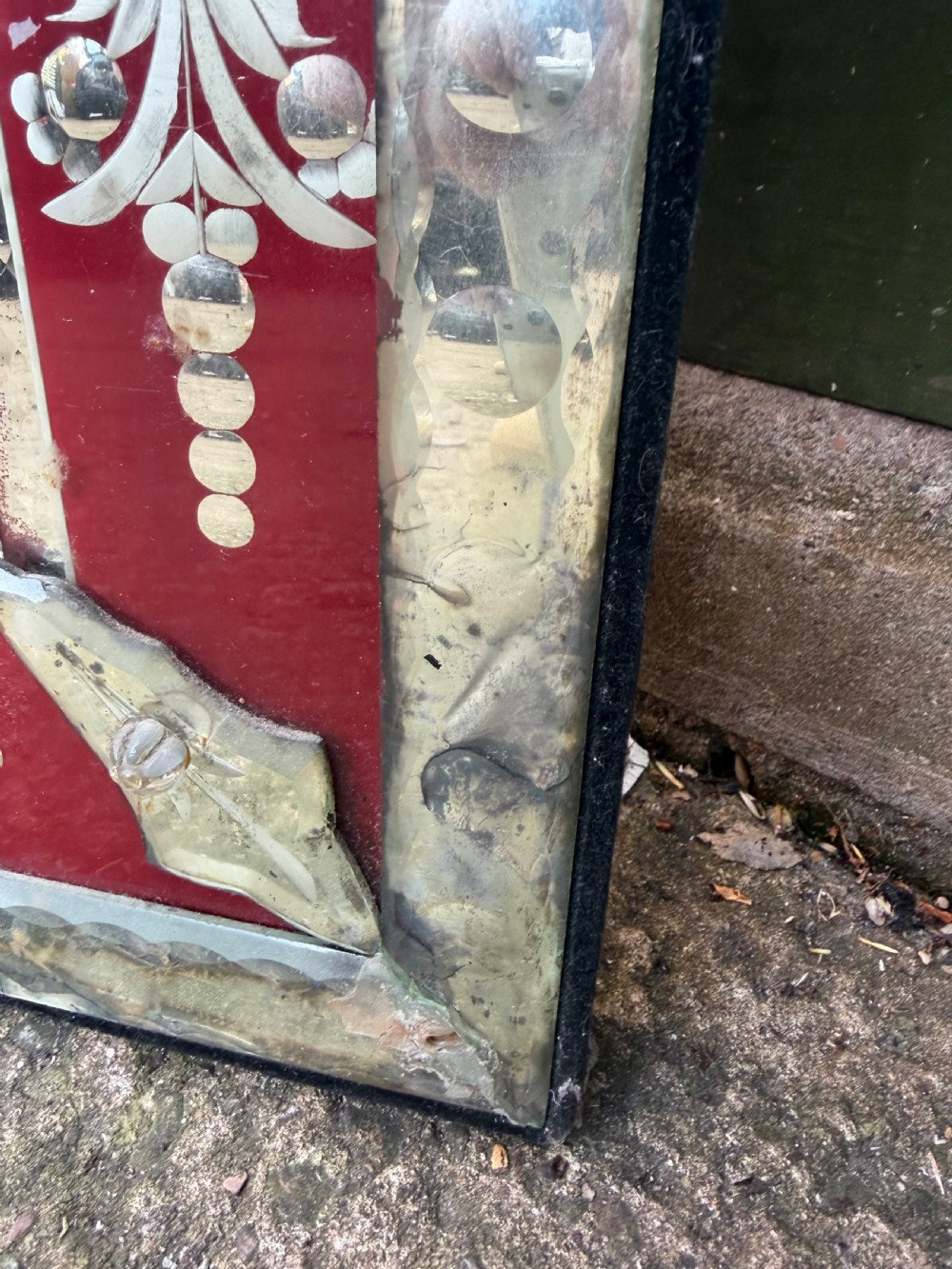 An antique Venetian wall mirror featuring cut and etched glass borders with ruby red glass accents and a decorative pediment crest. View XI