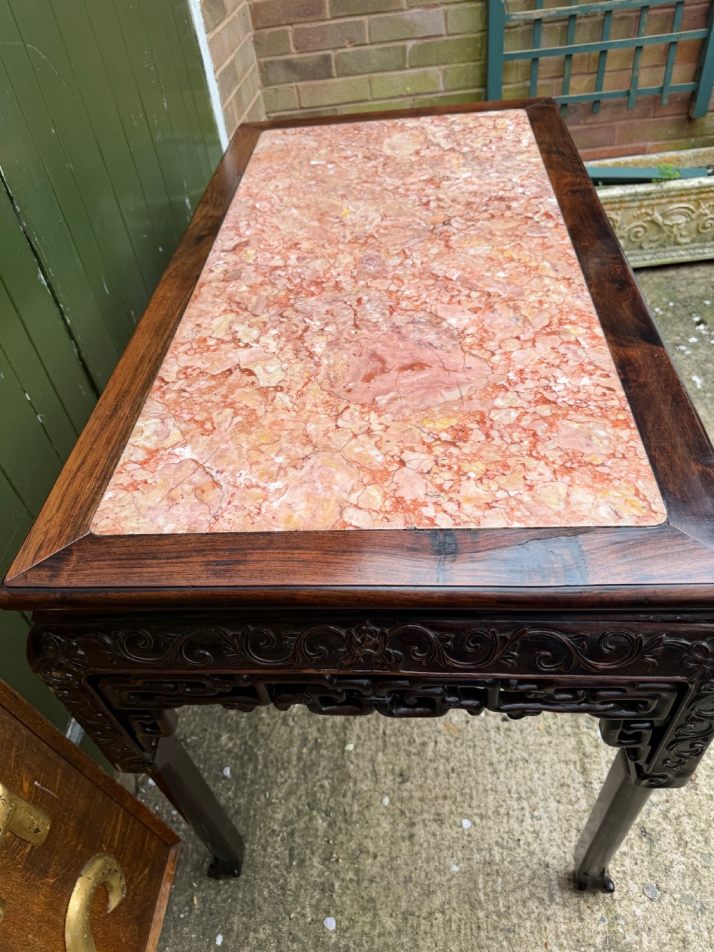 Late 19th-century Chinese Qing Dynasty dark hardwood centre table featuring an inset pink rouge marble rectangular top and intricately carved fretwork aprons. View VIII