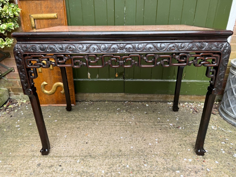Late 19th-century Chinese Qing Dynasty dark hardwood centre table featuring an inset pink rouge marble rectangular top and intricately carved fretwork aprons. View XI