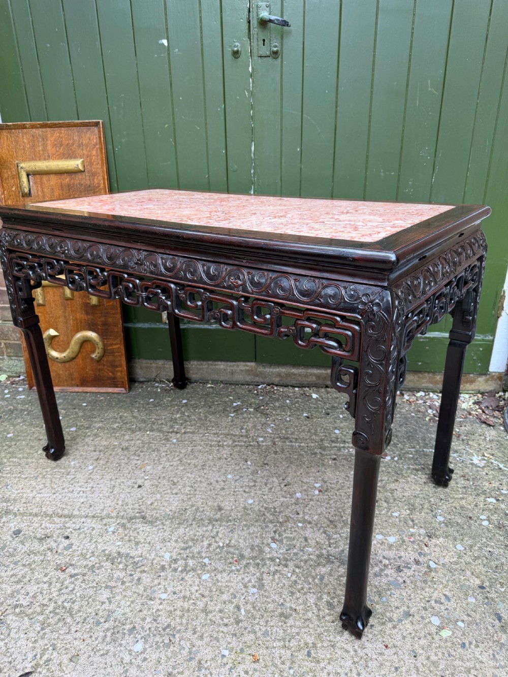 Late 19th-century Chinese Qing Dynasty dark hardwood centre table featuring an inset pink rouge marble rectangular top and intricately carved fretwork aprons. View XIII