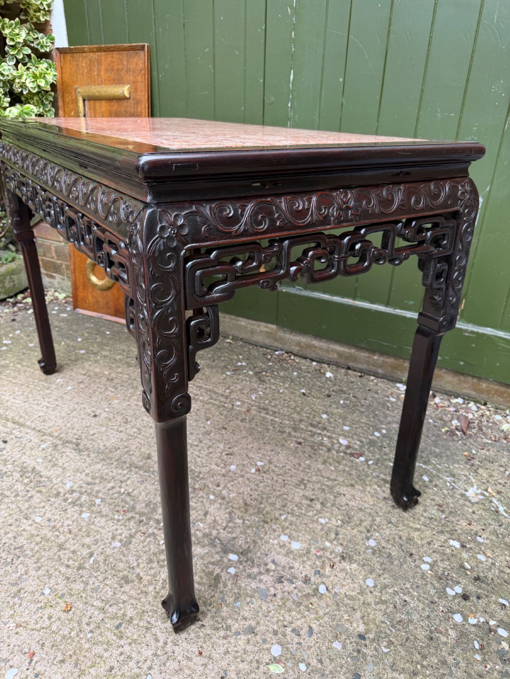 Late 19th-century Chinese Qing Dynasty dark hardwood centre table featuring an inset pink rouge marble rectangular top and intricately carved fretwork aprons. View XIV
