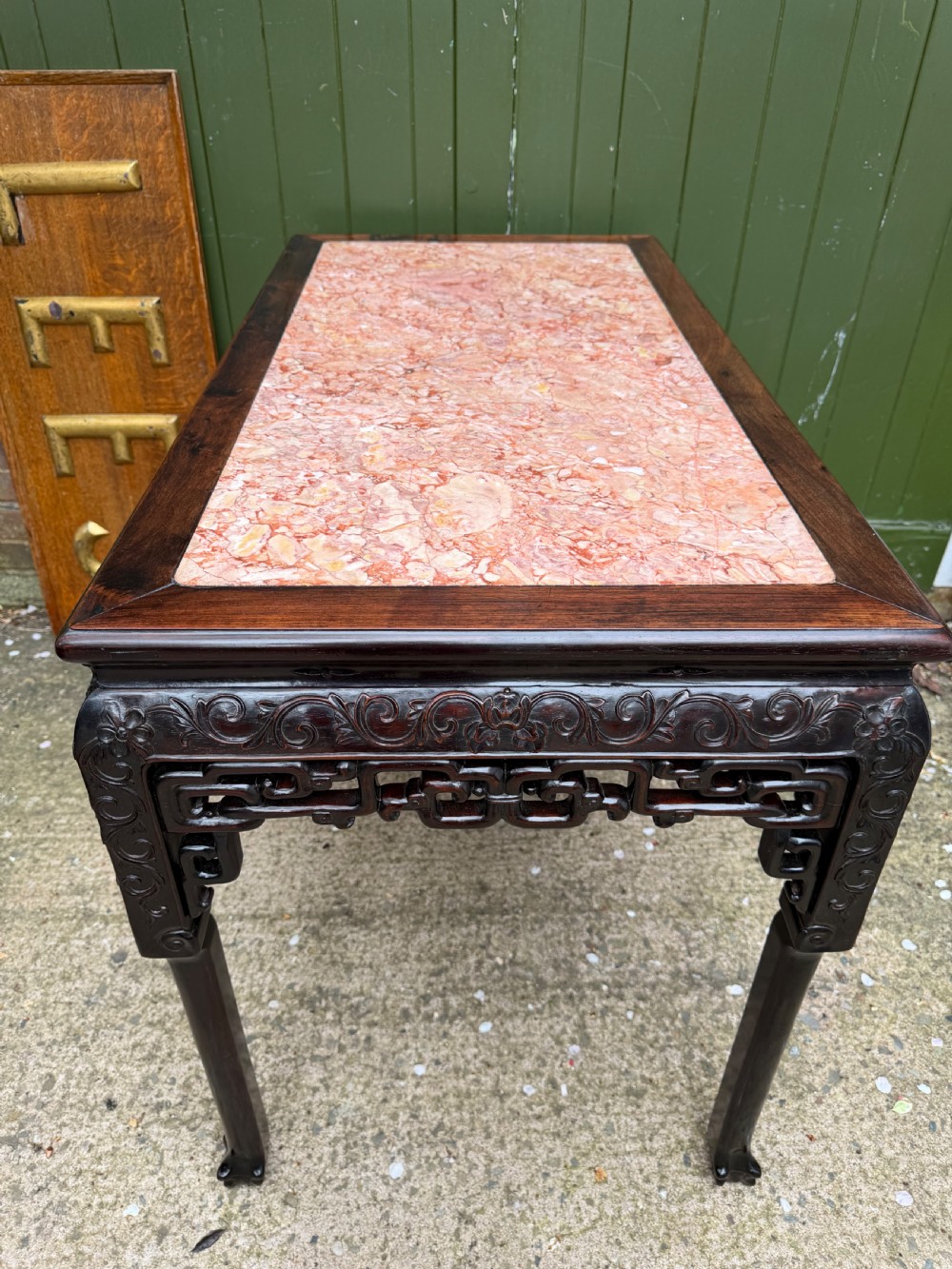 Late 19th-century Chinese Qing Dynasty dark hardwood centre table featuring an inset pink rouge marble rectangular top and intricately carved fretwork aprons. View XVIII