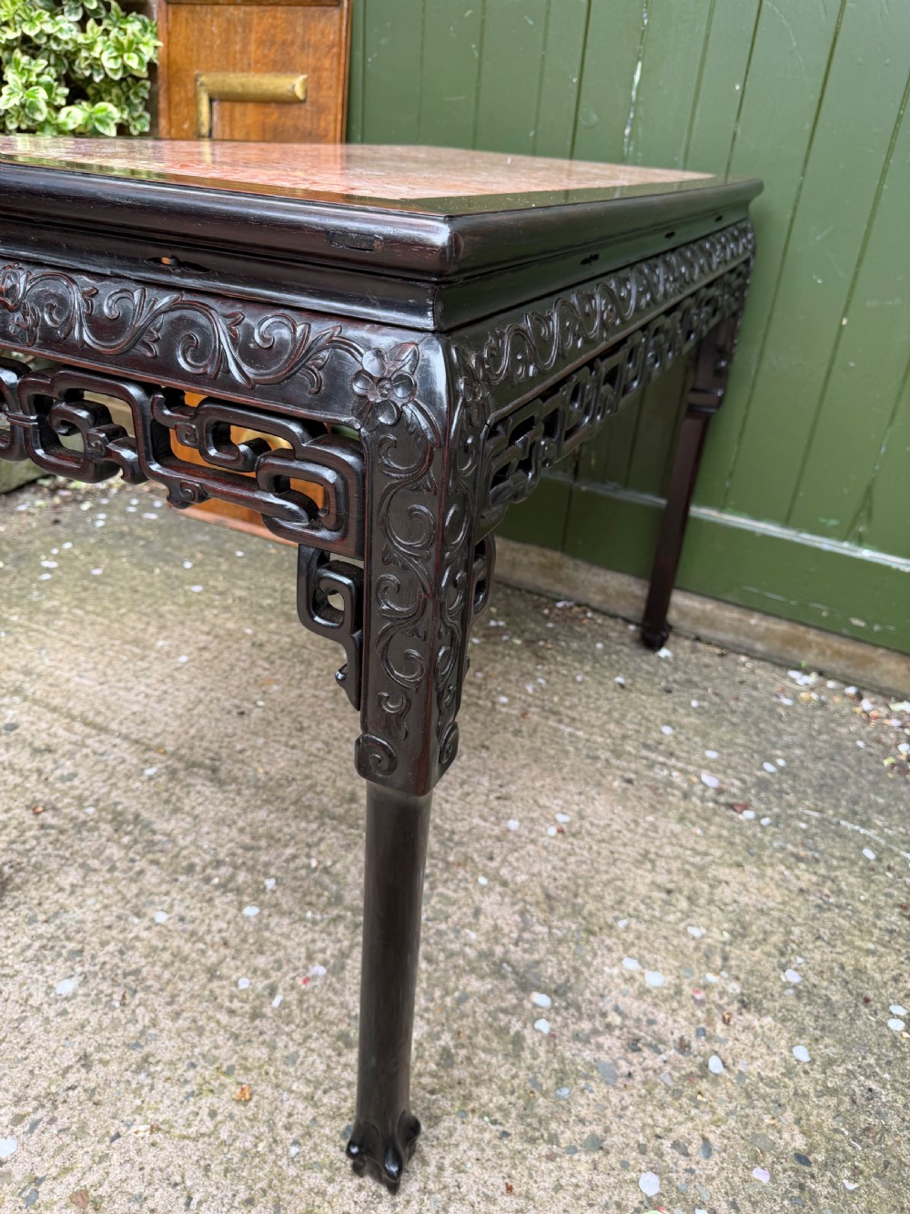 Late 19th-century Chinese Qing Dynasty dark hardwood centre table featuring an inset pink rouge marble rectangular top and intricately carved fretwork aprons. View XX