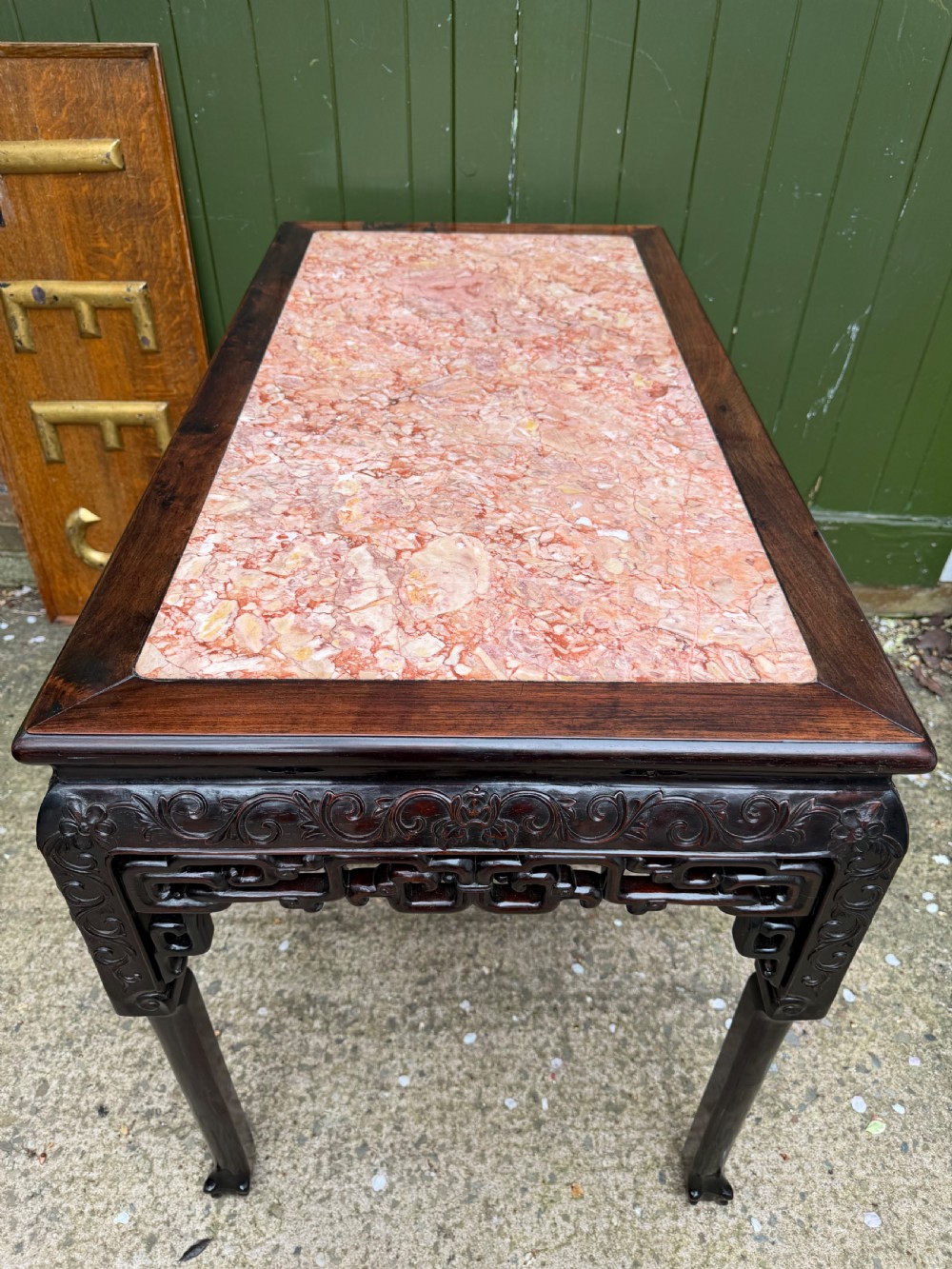Late 19th-century Chinese Qing Dynasty dark hardwood centre table featuring an inset pink rouge marble rectangular top and intricately carved fretwork aprons. View XXV