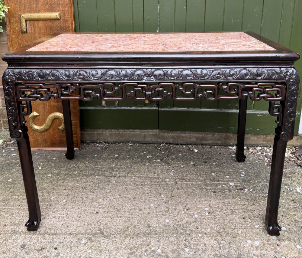 Late 19th-century Chinese Qing Dynasty dark hardwood centre table featuring an inset pink rouge marble rectangular top and intricately carved fretwork aprons. View XXVI