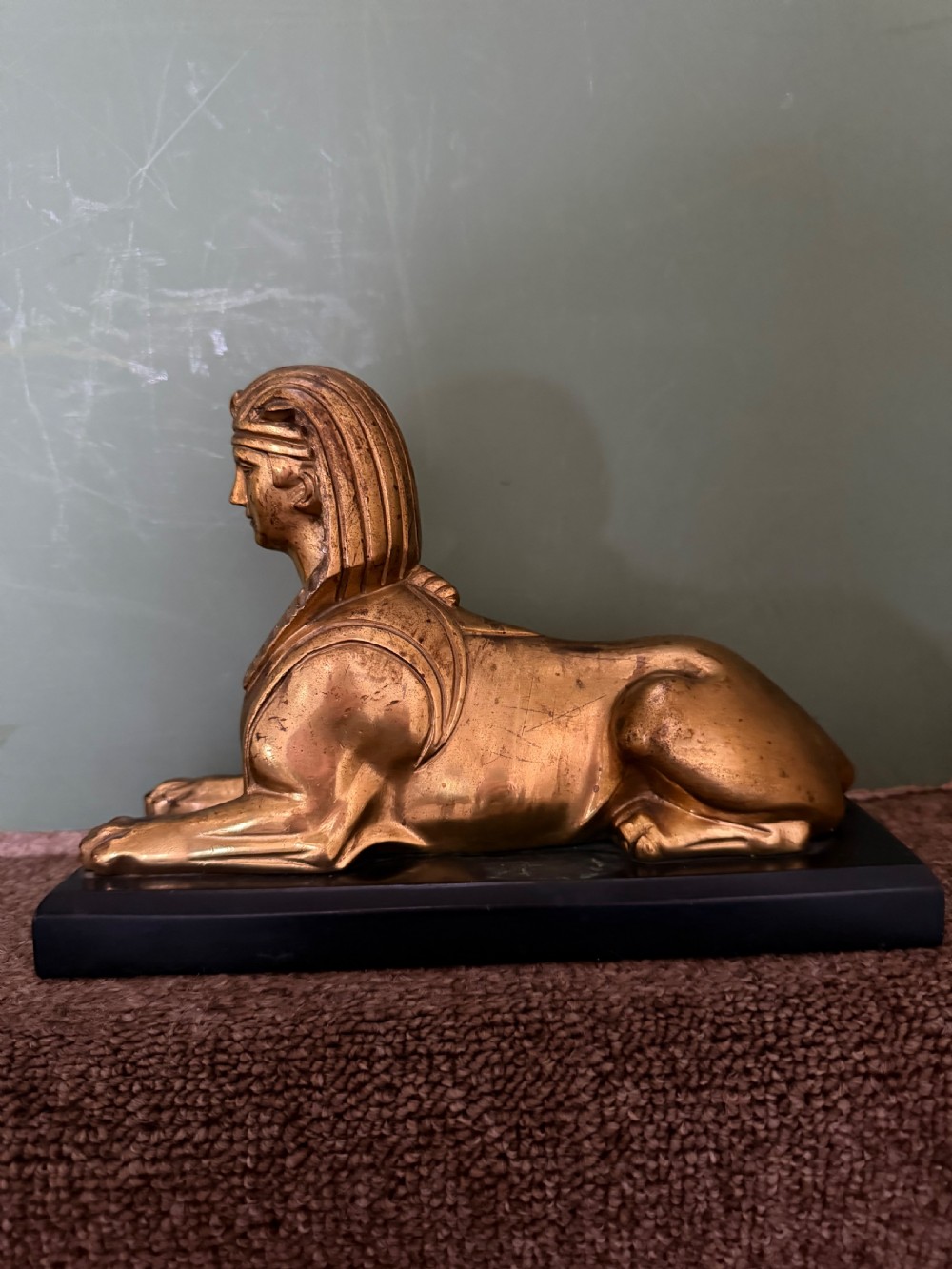 A pair of early nineteenth-century gilded bronze recumbent sphinxes resting on rectangular dark patinated bronze plinth bases. View IV