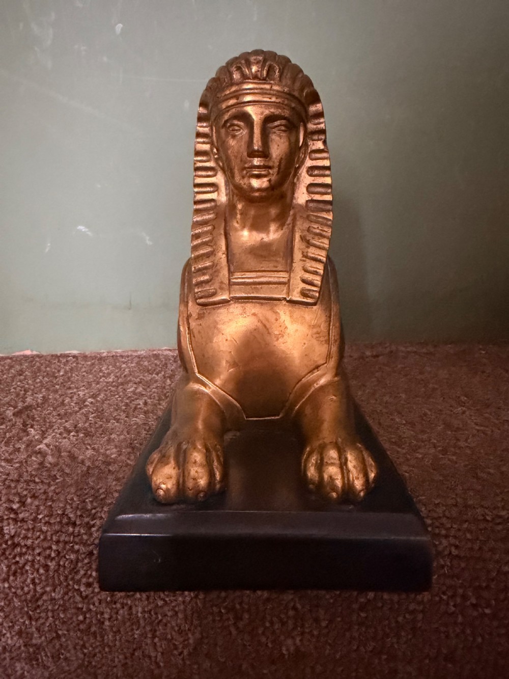 A pair of early nineteenth-century gilded bronze recumbent sphinxes resting on rectangular dark patinated bronze plinth bases. View IX