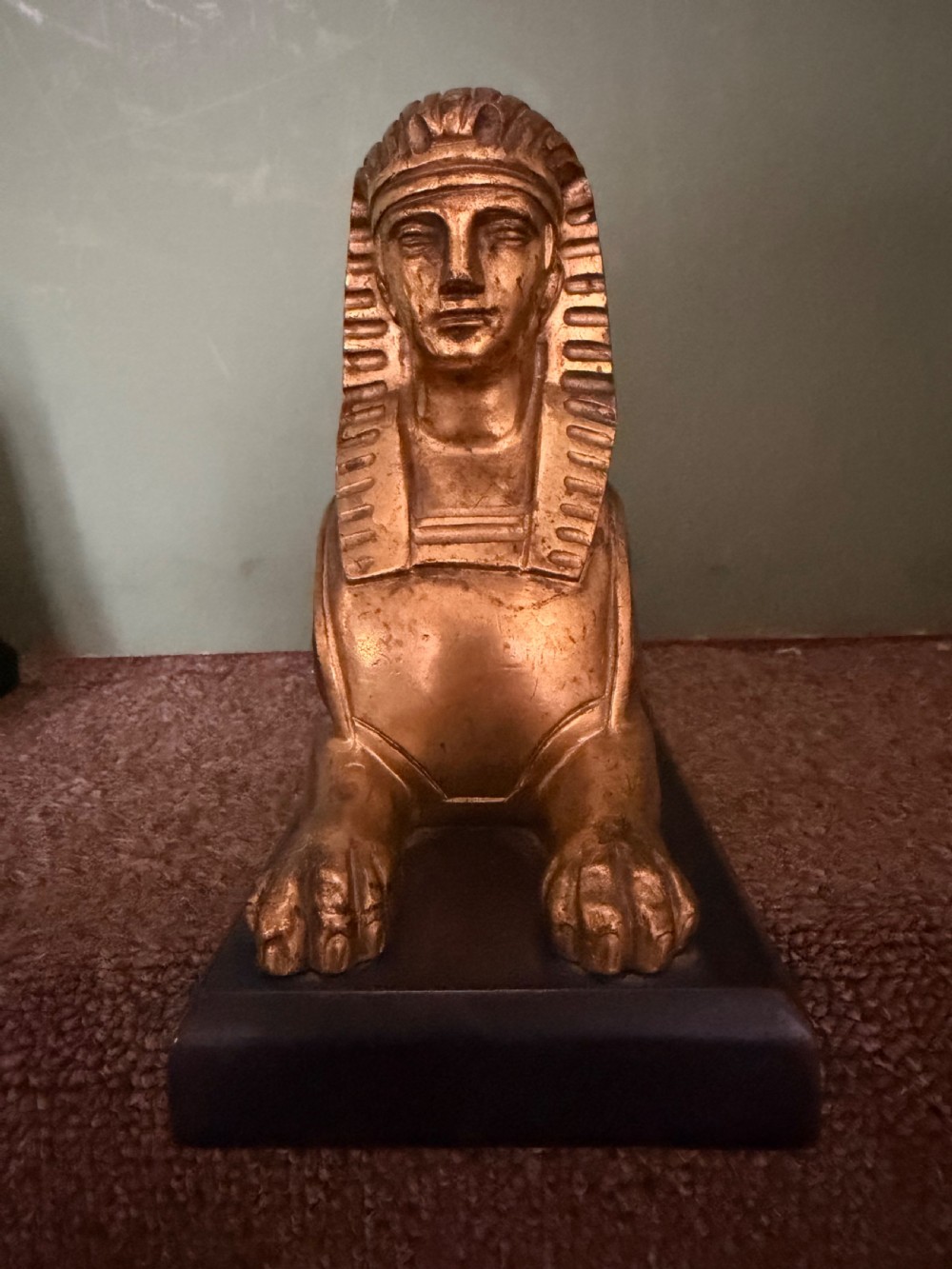A pair of early nineteenth-century gilded bronze recumbent sphinxes resting on rectangular dark patinated bronze plinth bases. View X