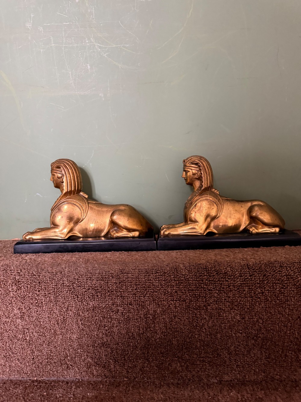 A pair of early nineteenth-century gilded bronze recumbent sphinxes resting on rectangular dark patinated bronze plinth bases. View XI