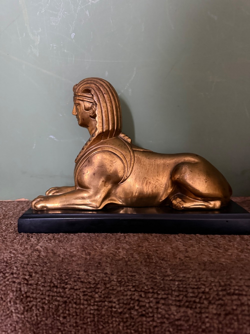 A pair of early nineteenth-century gilded bronze recumbent sphinxes resting on rectangular dark patinated bronze plinth bases. View XII