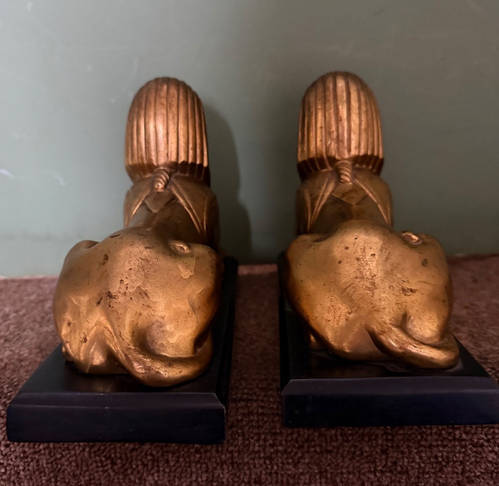 A pair of early nineteenth-century gilded bronze recumbent sphinxes resting on rectangular dark patinated bronze plinth bases. View XIV