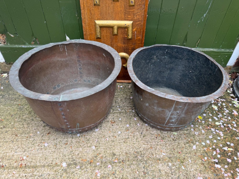 A matched pair of 19th-century copper wash tubs with riveted seams, wide rolled rims, and natural verdigris oxidisation. View II