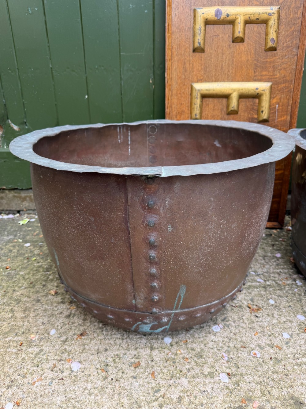 A matched pair of 19th-century copper wash tubs with riveted seams, wide rolled rims, and natural verdigris oxidisation. View V