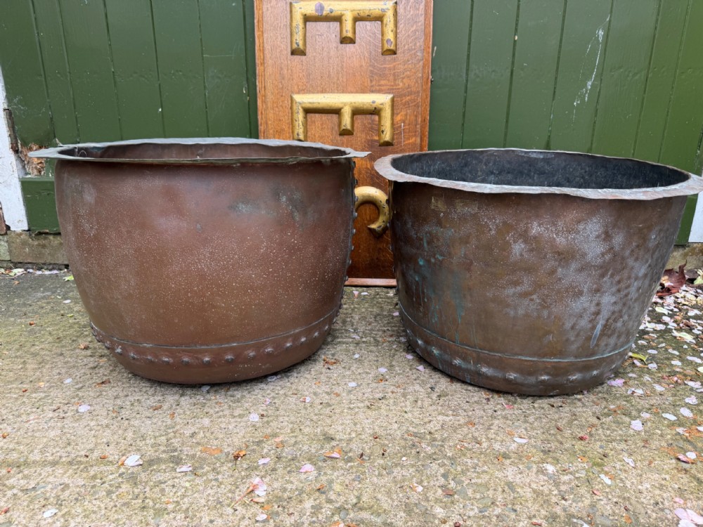 A matched pair of 19th-century copper wash tubs with riveted seams, wide rolled rims, and natural verdigris oxidisation. View VI